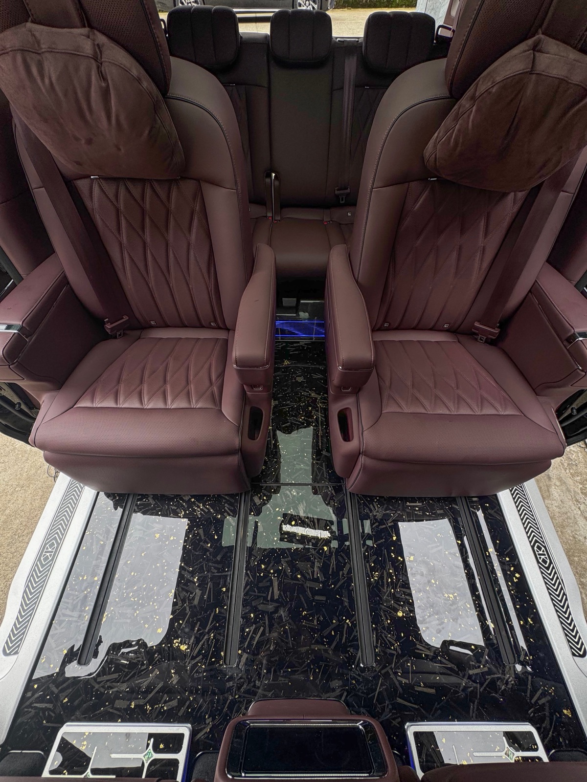 Cabin of a completed luxury MPV with a starry black wooden floor kit