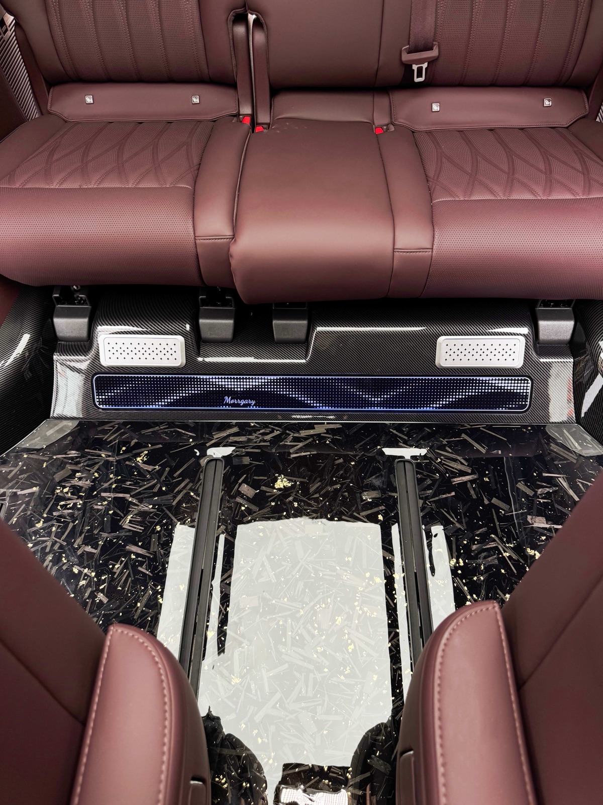 Starry black floor with gold fleck and illuminated door sill in a completed luxury MPV installation